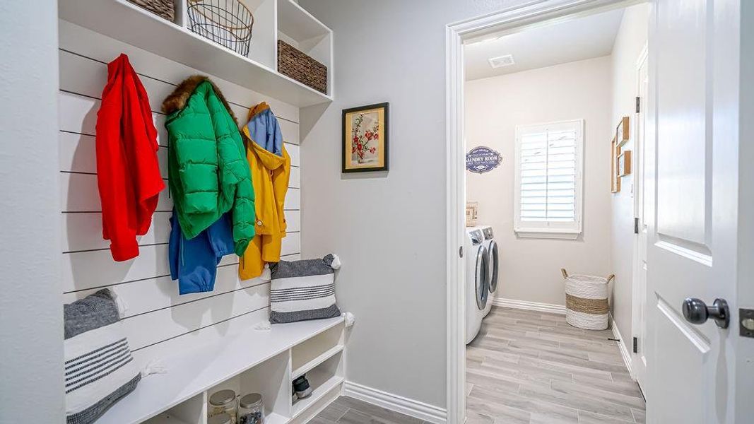 Mudroom with light wood-type flooring and independent washer and dryer