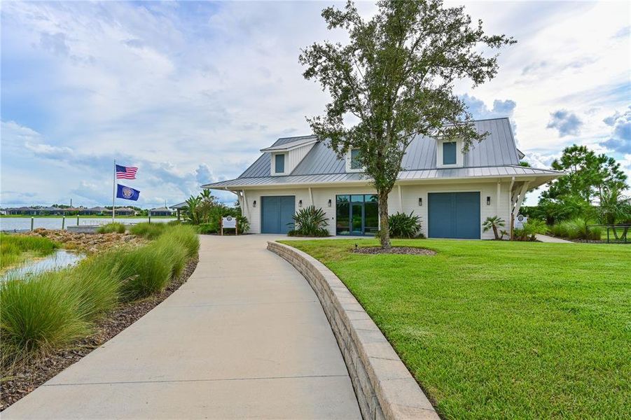 Front exterior of a new home in LakeHouse Cove at Waterside, Sarasota, FL, highlighting curb appeal (Image 24).