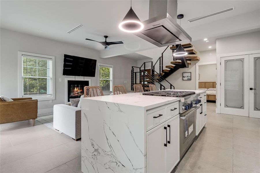 An open-concept living space with a contemporary kitchen island and a cozy fireplace.