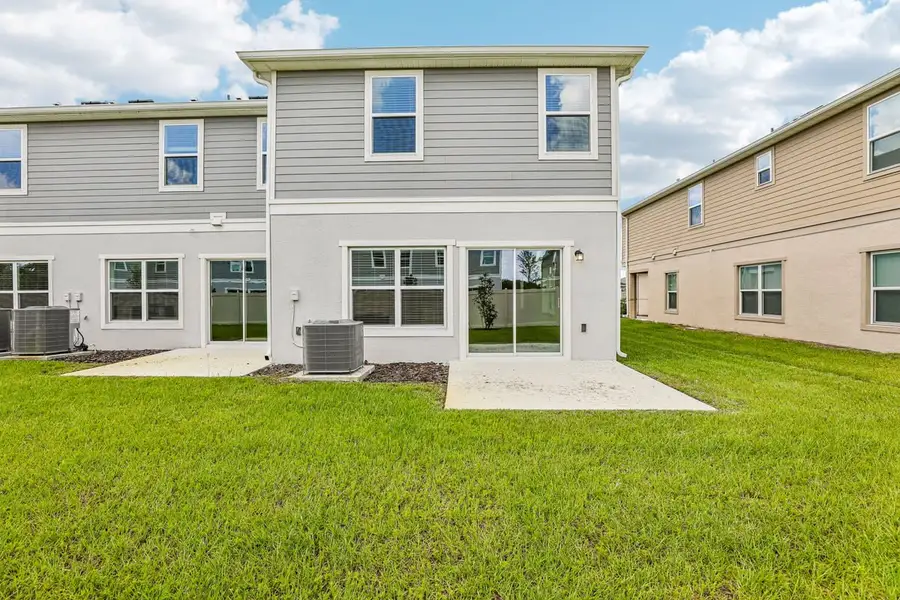 Exterior details and patio area of a home in Reserve at Forest Lake Townhomes, Lake Wales (Image 3).