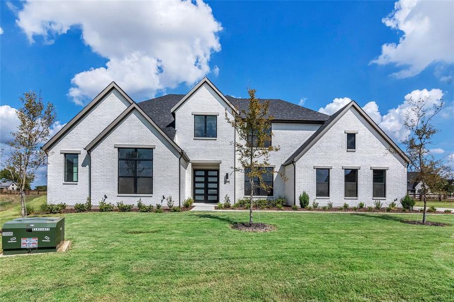 French provincial home with a front lawn