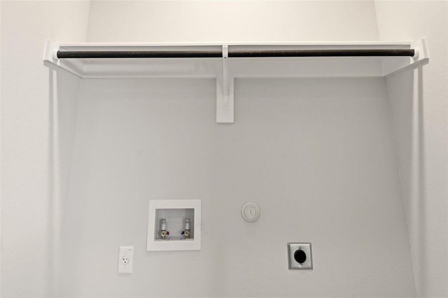 Laundry area with hookup for a gas dryer, washer hookup, and hookup for an electric dryer