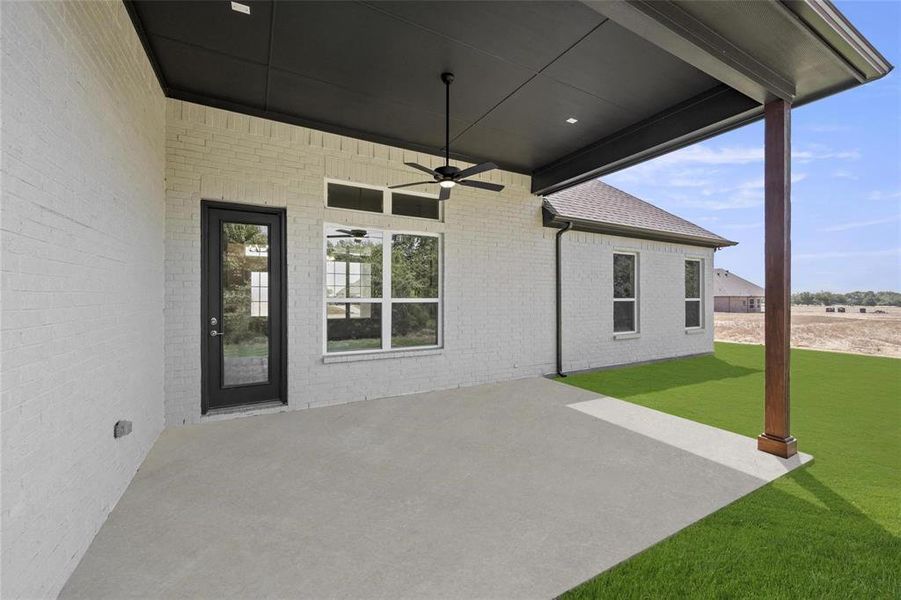 View of patio featuring ceiling fan