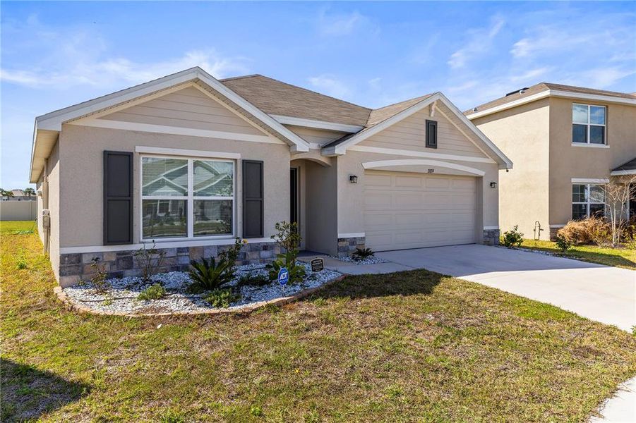 Front exterior of a new home in Berry Bay, Wimauma, FL, highlighting curb appeal (Image 21). Front exterior of a new home in Berry Bay, Wimauma, FL, highlighting curb appeal (Image 21).
