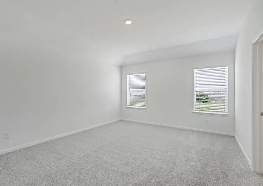 Master bedroom with two windows facing the backyard