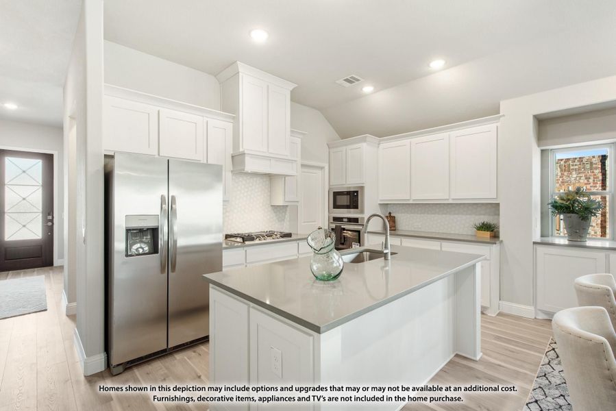 Kitchen with white cabinets, center island with sink, stainless steel appliances, and light wood floors Kitchen with white cabinets, center island with sink, stainless steel appliances, and light wood floors