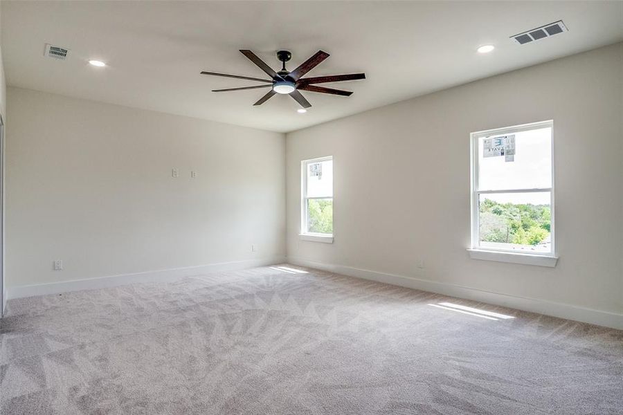 Empty room featuring ceiling fan, recessed lighting, and carpet floors