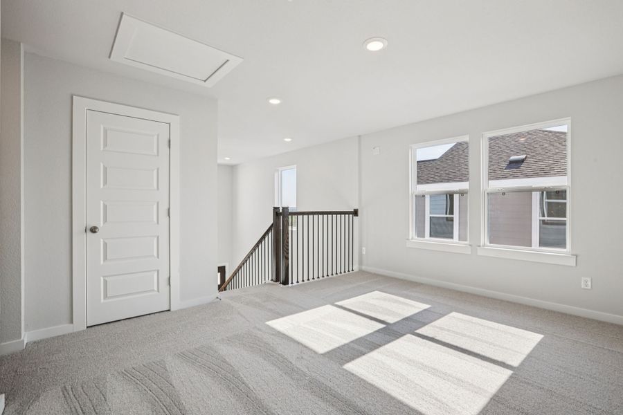 A room with a rug and a door.