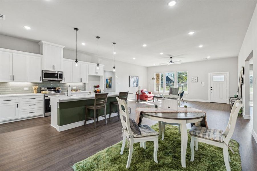 Dining space featuring ceiling fan, dark wood-type flooring, and recessed lighting