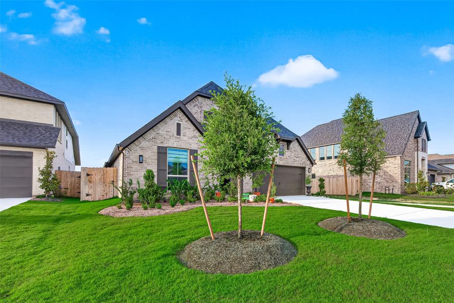 Front exterior of a new home in StoneCreek Estates, Richmond, TX, highlighting curb appeal (Image 25). Front exterior of a new home in StoneCreek Estates, Richmond, TX, highlighting curb appeal (Image 25).