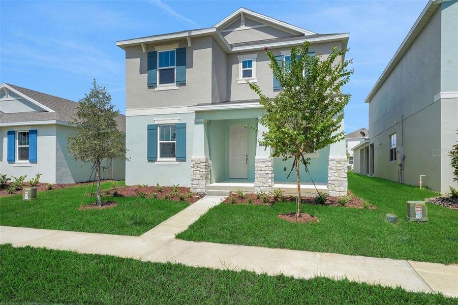Front exterior of a new home in Crossroads at Kelly Park, Apopka, FL, highlighting curb appeal (Image 23).