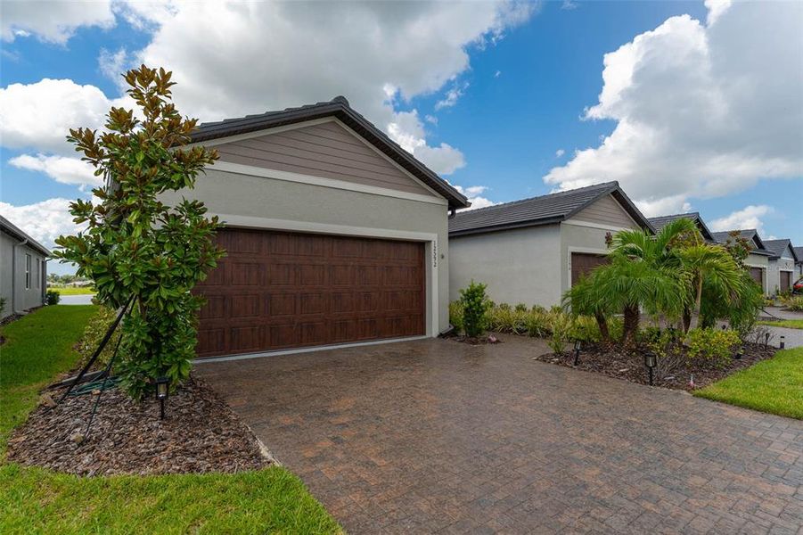 Front exterior of a new home in Prosperity Lakes Active Adult, Parrish, FL, highlighting curb appeal (Image 2).