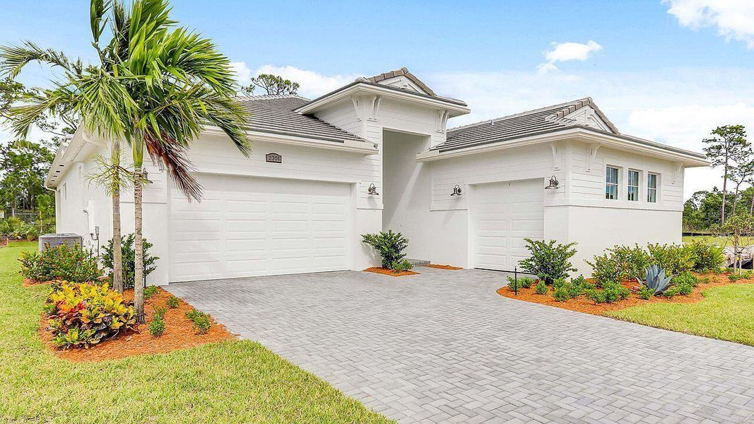 Front exterior of a new home in Mosaic, Port St. Lucie, FL, highlighting curb appeal (Image 2).