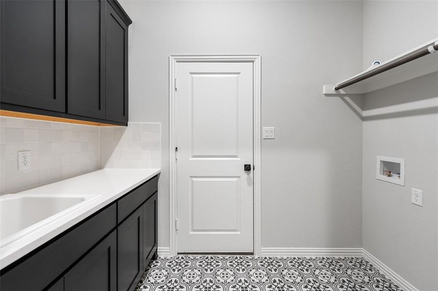 Laundry area featuring washer hookup and cabinet space Laundry area featuring washer hookup and cabinet space