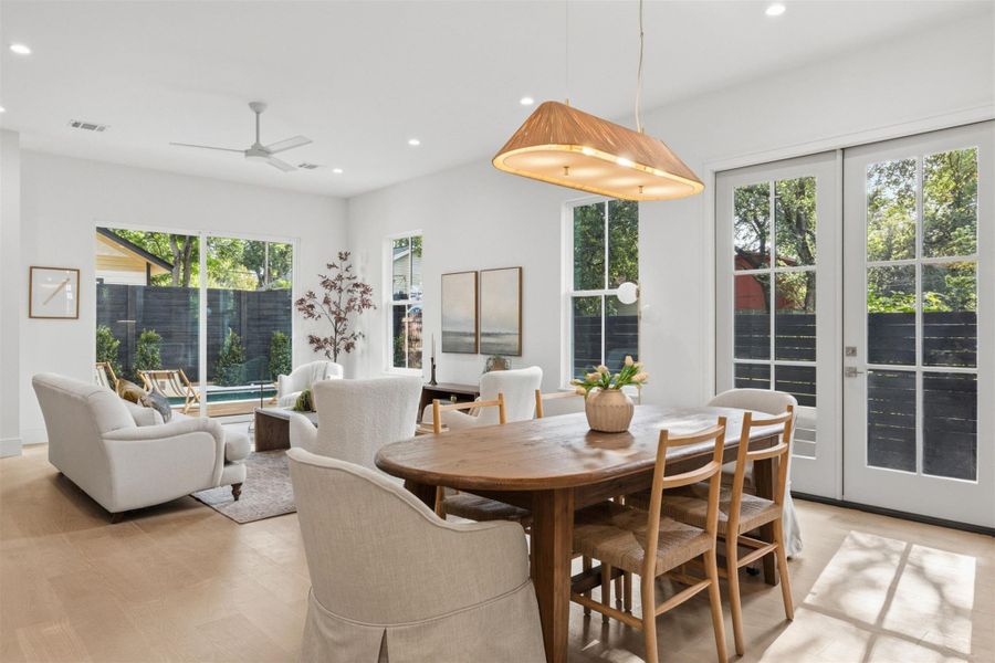 An inviting open-concept living and dining area with abundant natural light and outdoor access.