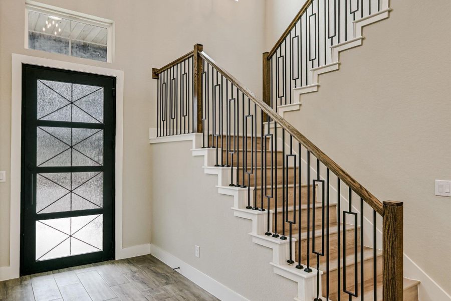 Entryway featuring light wood-type flooring and a high ceiling