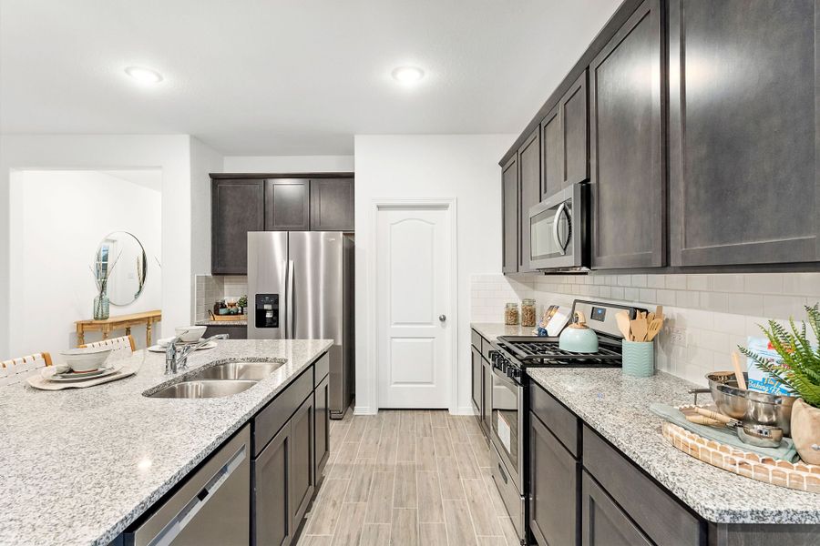 A kitchen with black cabinets. A kitchen with black cabinets.
