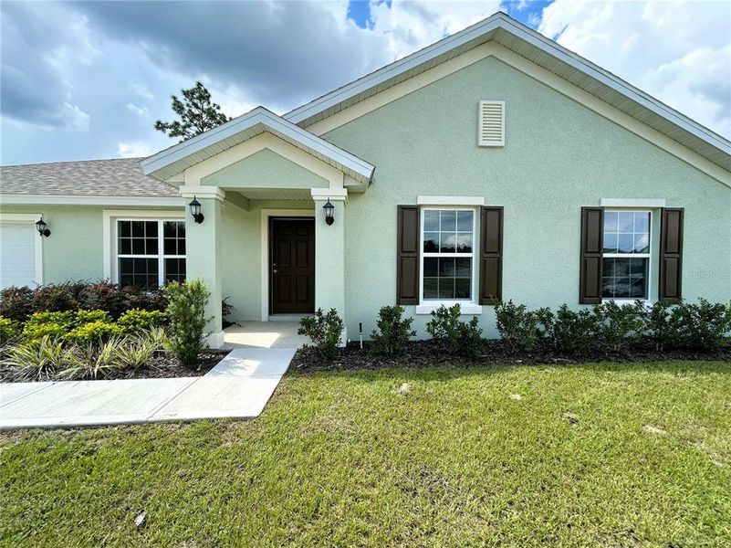 Front exterior of a new home in , Citrus Springs, FL, highlighting curb appeal (Image 10).