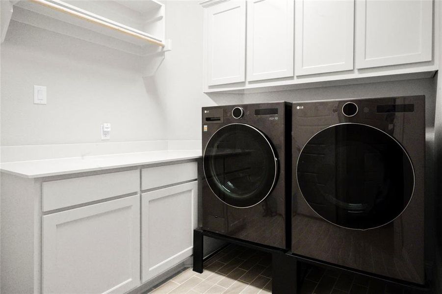 Washroom with washer and clothes dryer and cabinet space Washroom with washer and clothes dryer and cabinet space