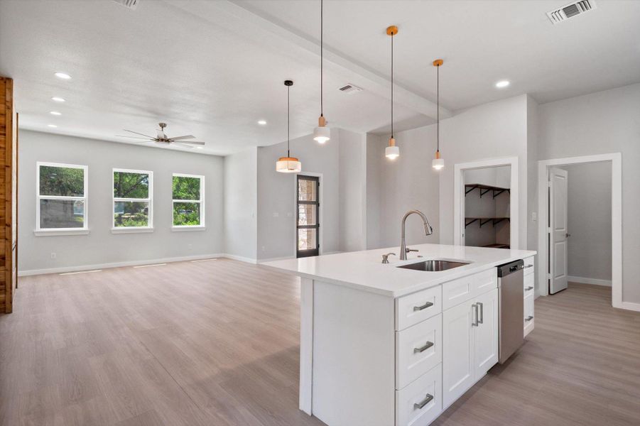 An open-concept living space with a contemporary kitchen island and generous natural light.