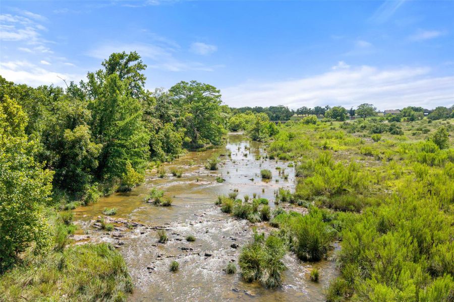 Aerial view of property and surrounding area with a large body of water
