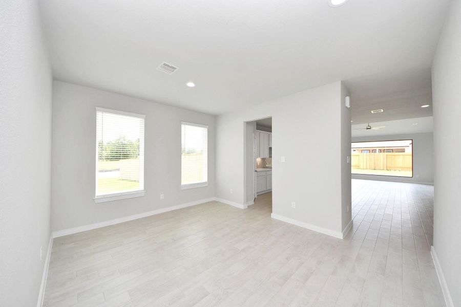 Create lasting memories with your family and friends at the dining table! This expansive dining room showcases sophisticated flooring, custom paint, and seamlessly connects to the family room and kitchen, providing an open and inviting atmosphere. Create lasting memories with your family and friends at the dining table! This expansive dining room showcases sophisticated flooring, custom paint, and seamlessly connects to the family room and kitchen, providing an open and inviting atmosphere.