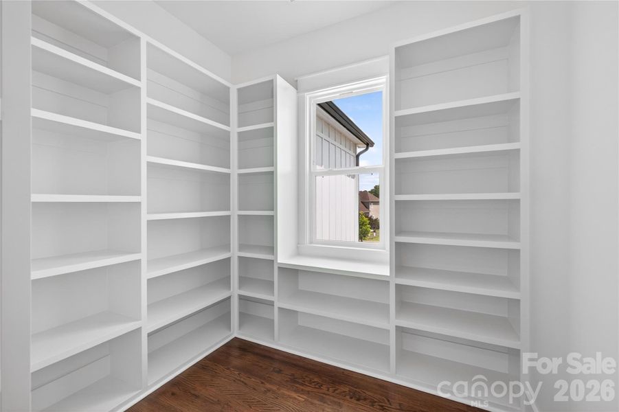 A walk-in pantry with custom built-ins and enough space to keep everything organized without sacrificing style