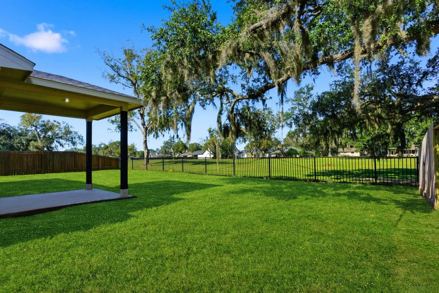 Enjoy breathtaking views from your private backyard, perfectly positioned along the Columbia Lakes Golf Course! The covered back patio is ideal for outdoor dining or relaxing under the shade of mature oak trees draped with Spanish moss. The wide-open lawn provides plenty of space for recreation or pets, while the wrought-iron fence allows you to take in the serene golf course scenery—creating the perfect blend of comfort and resort-style living.