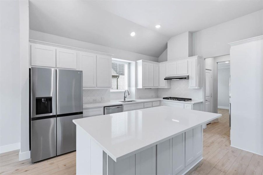 Open-concept kitchen overlooking the dining and living areas, ideal for everyday living and entertaining.