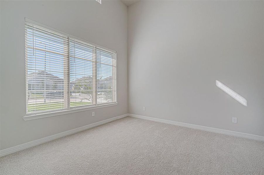 Large windows in the study/home office with accent picture windows above allow light to fill the room.