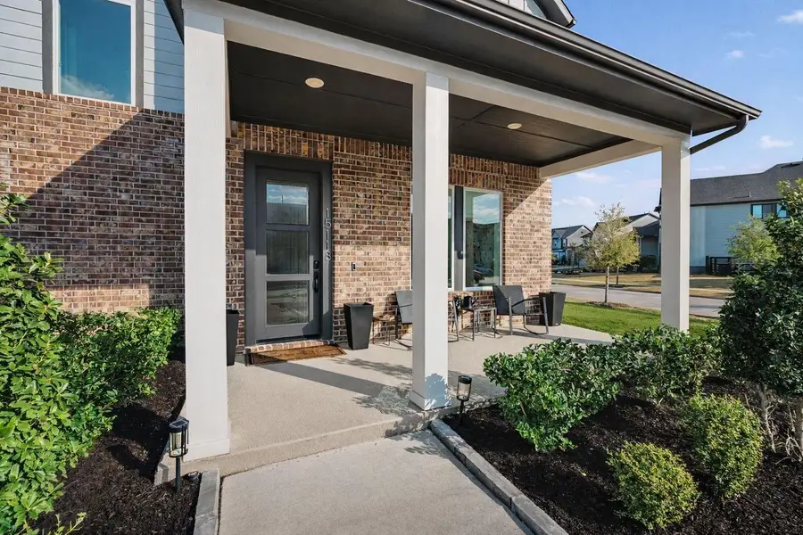 Charming covered front porch with modern farmhouse curb appeal, brick accents, and welcoming entry—perfect for relaxing and enjoying the neighborhood.