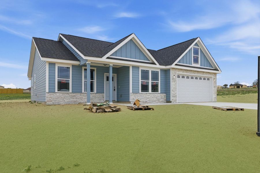 Front exterior of a new home in Las Palomas Country Club Estates, La Vernia, TX, highlighting curb appeal (Image 16).