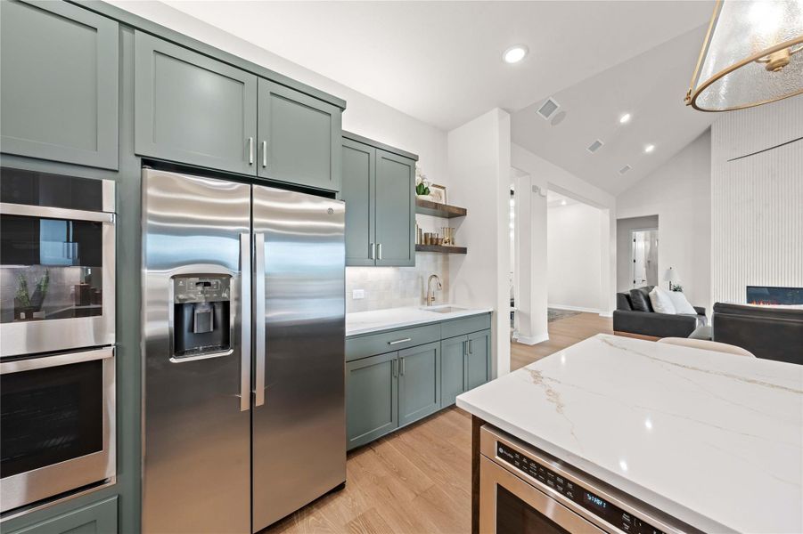 A well-appointed kitchen features stainless steel appliances, gleaming countertops, and durable hardwood flooring. A well-appointed kitchen features stainless steel appliances, gleaming countertops, and durable hardwood flooring.