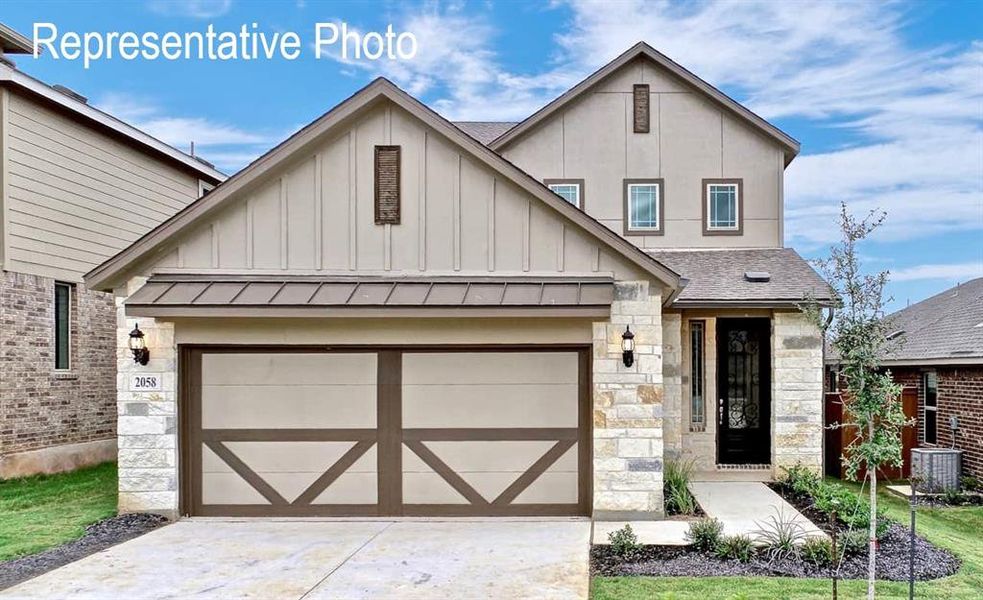 View of front of house featuring central AC unit and a garage