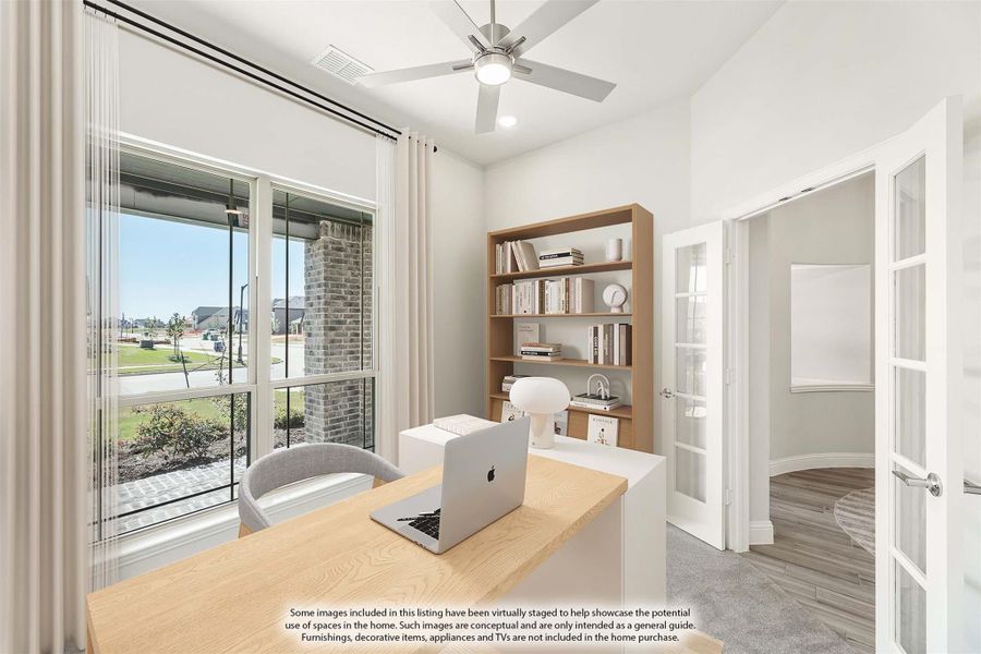 Home office with wood desk, bookshelf, ceiling fan, and large windows overlooking neighborhood