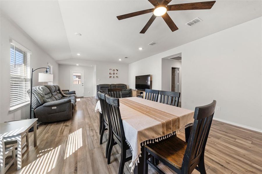 Dining room with vaulted ceiling, recessed lighting, light wood-style floors, and ceiling fan