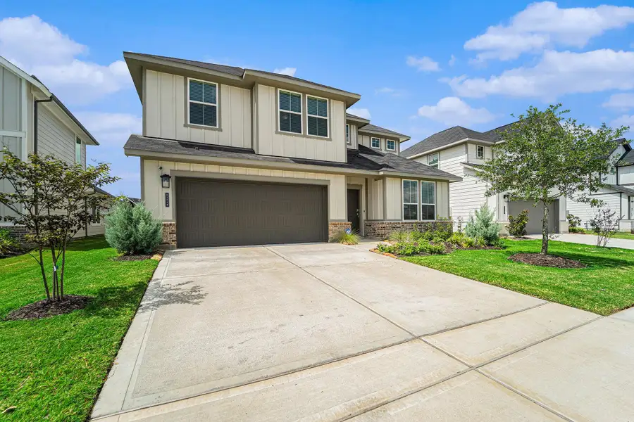 Front exterior of a new home in The Timbers at Mason Woods, Cypress, TX, highlighting curb appeal (Image 2). Front exterior of a new home in The Timbers at Mason Woods, Cypress, TX, highlighting curb appeal (Image 2).