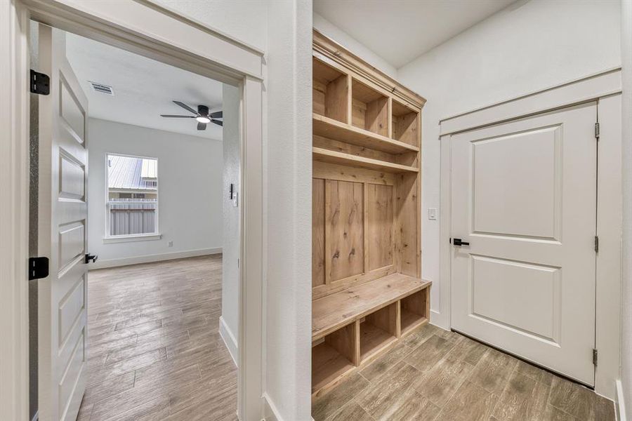 Mudroom with wood tiled floors and ceiling fan