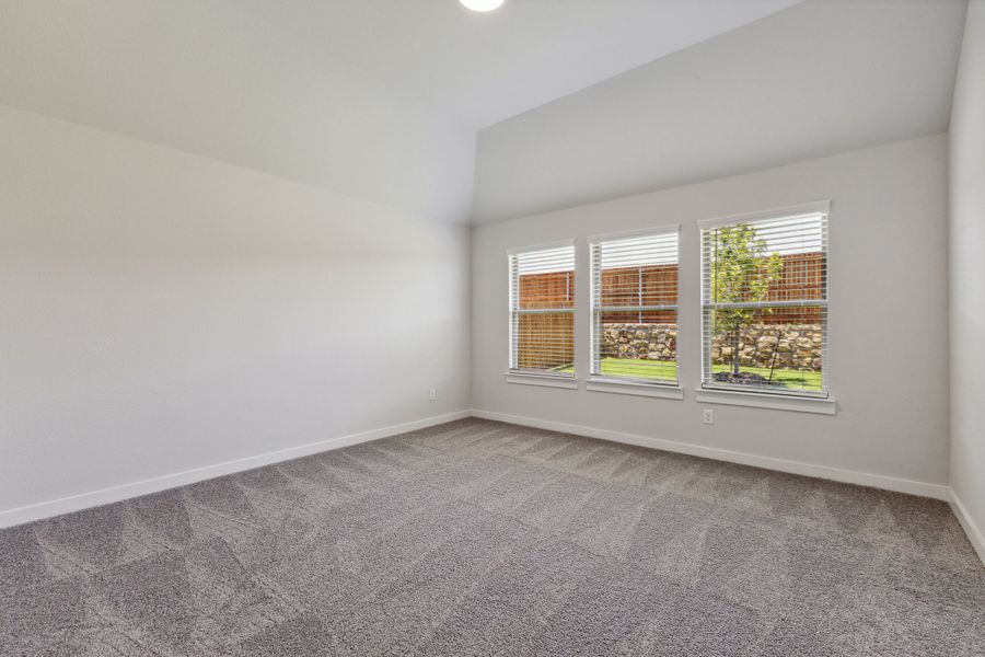 Primary bedroom in the Quartz home plan by Trophy Signature Homes – REPRESENTATIVE PHOTO