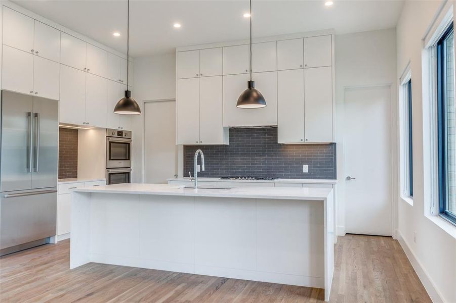 Sleek feel in this beautiful and efficent kitchen with a ton of cabinet space