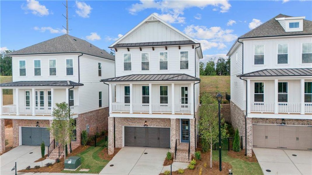 Front exterior of a new home in Palisades Single Family, Cumming, GA, highlighting curb appeal (Image 16).