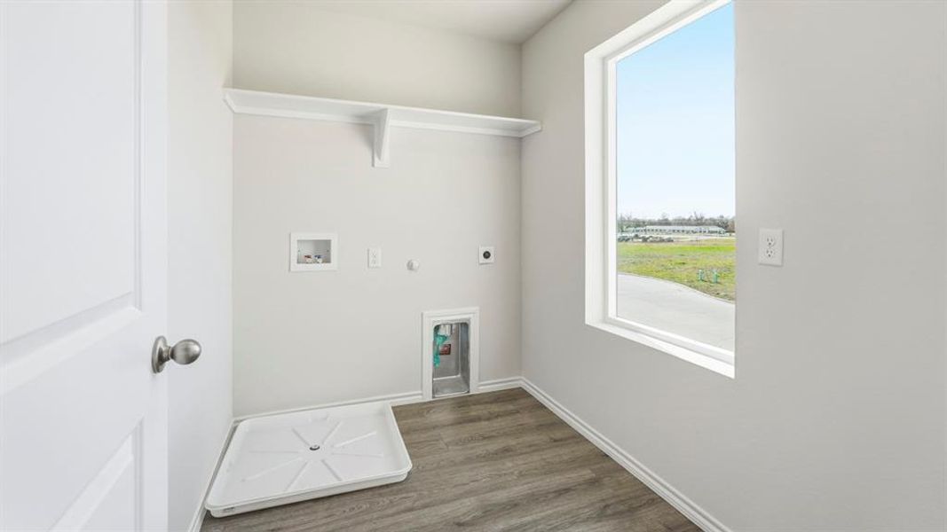 Laundry area with hookup for a gas dryer, electric dryer hookup, washer hookup, and dark wood-type flooring