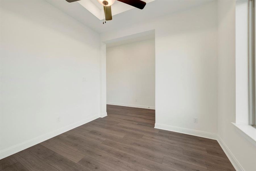 Spare room featuring dark wood finished floors and a ceiling fan Spare room featuring dark wood finished floors and a ceiling fan