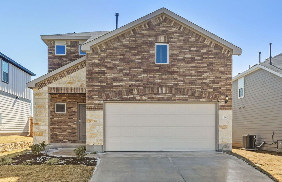 Front exterior of a new home in Sunfield, Buda, TX, highlighting curb appeal (Image 18).