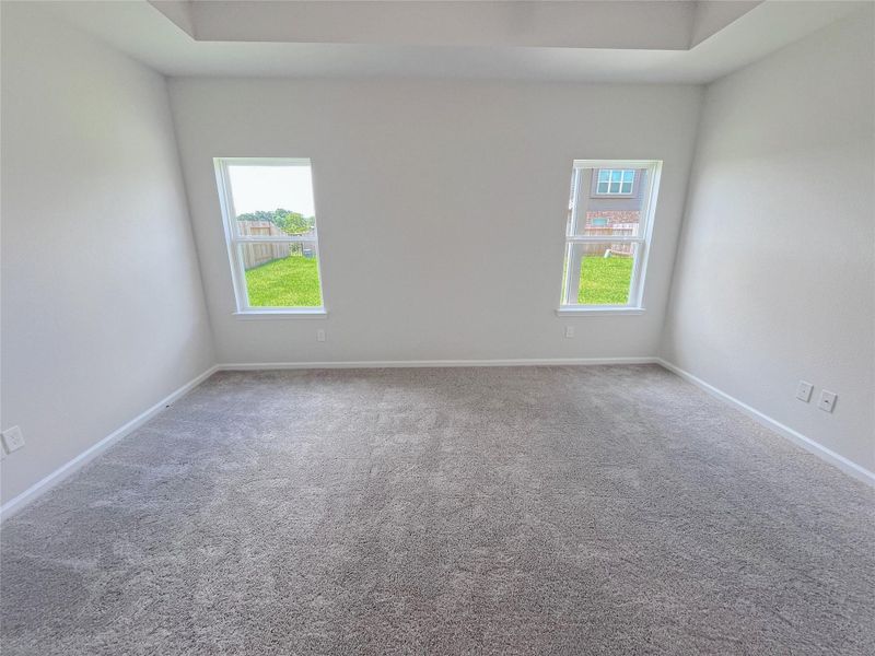 The Georgetown II- Primary Bedroom, Tray Ceiling not Included. Home under construction. Sample floor plan photo used for illustrative purposes only. Upgrades, selections options, windows and colors may vary.