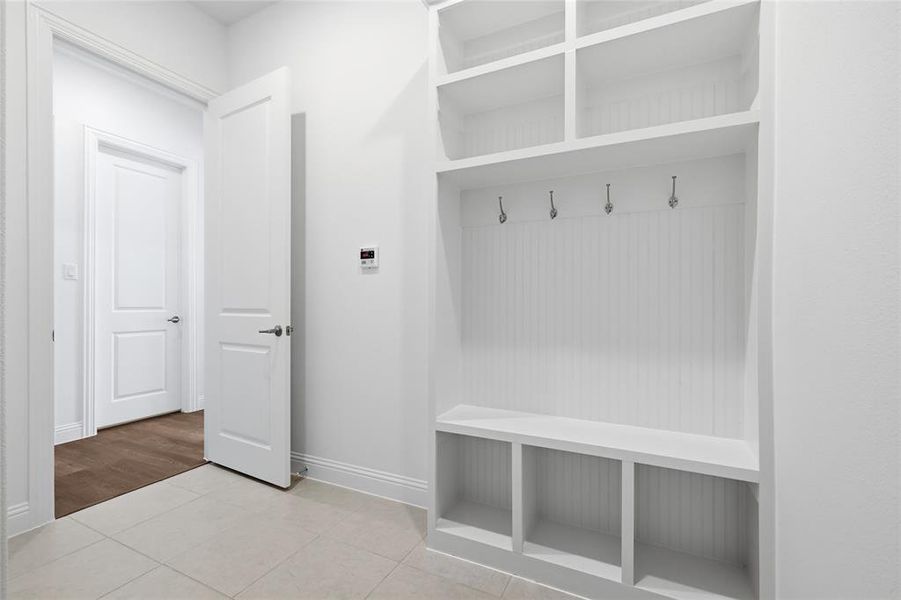 Mudroom with light tile patterned flooring Mudroom with light tile patterned flooring