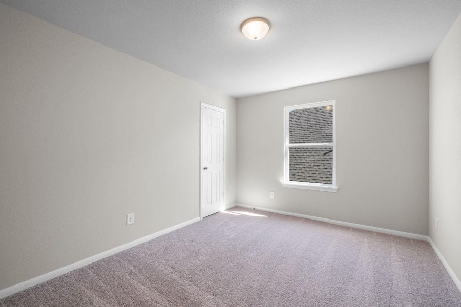Your secondary bedroom features plush carpet, fresh paint, closet, and a large window that lets in plenty of natural lighting.