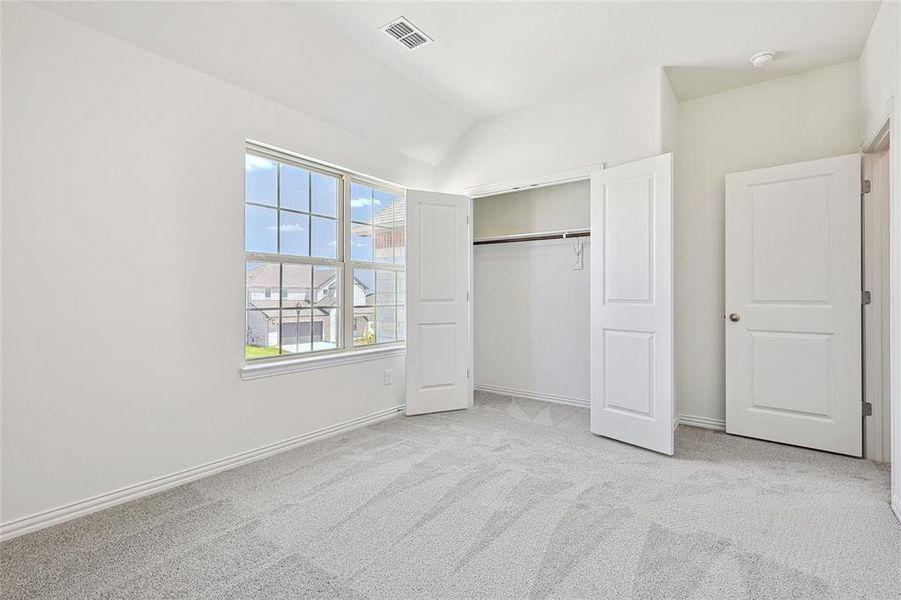 Unfurnished bedroom with a closet and light carpet