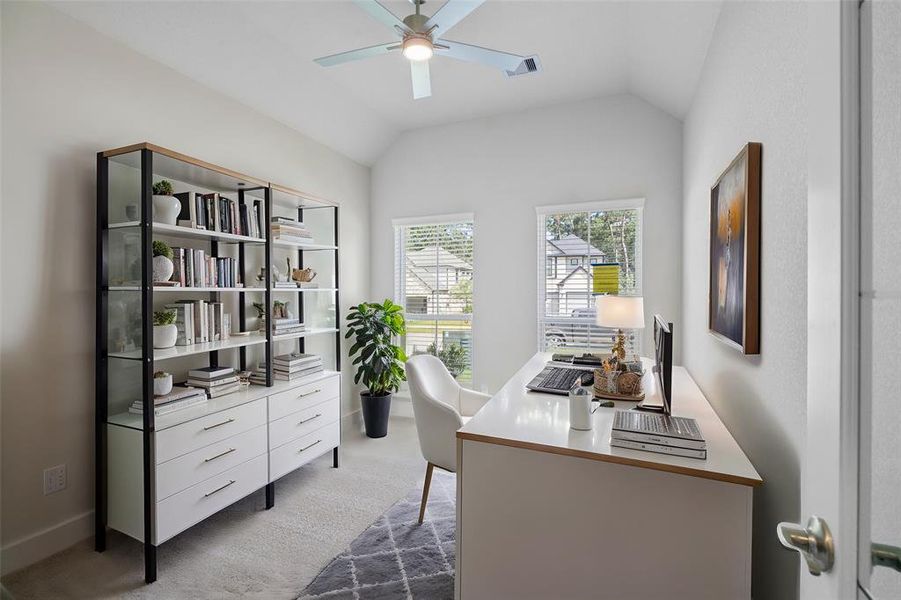 Nestled away quietly in the front of the home is the handsome home office! Featuring high ceilings, ceiling fan, custom paint, plush carpet flooring, and large windows with privacy blinds!