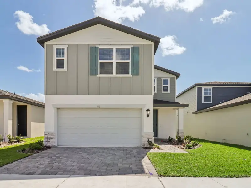 Front exterior of a new home in The Reserve at Hammock Oaks - Classic Series, Lady Lake, FL, highlighting curb appeal (Image 1). Front exterior of a new home in The Reserve at Hammock Oaks - Classic Series, Lady Lake, FL, highlighting curb appeal (Image 1).